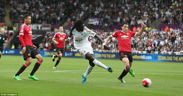Bafetimbi Gomis (centre) slots the ball under the body of Sergio Romero to secure Swansea's comeback win against Manchester United