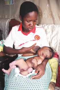 Grace Zimbowa breastfeeds the child, Tinashe