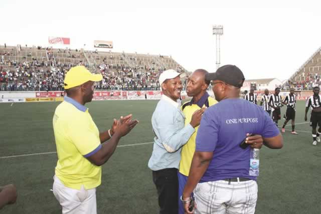 SUPER COMBINATION . . . Harare City chairman, Leslie Gwindi, hugs his coach, Bigboy Mawiwi, at Rufaro on Sunday after the Sunshine Boys moved closer to league championship glory with a 4-0 destruction of Highlanders