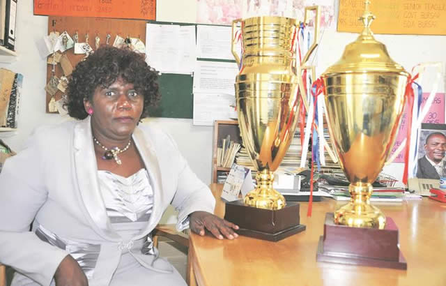 CHAMPIONS’ POSSESSIONS. . . Zimbabwe Handball Federation’s marketing manager Joan Takafuma displays some of the trophies for the President’s Tournament set for Saturday and Sunday at Houghton Park Primary School in Harare