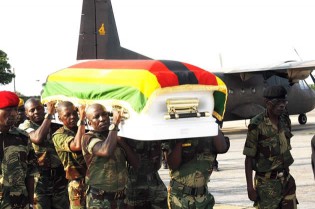 Pallbearers carry a casket bearing the body of national hero Cde Harold Chirenda on arrival at Manyame Airbase in Harare yesterday. — (See story on Page 2)
