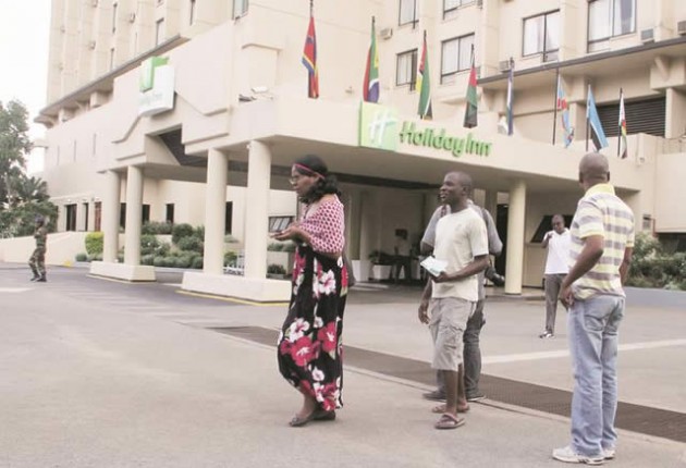 Journalists take notes at Holiday Inn Harare after guests and staff at the hotel were evacuated for more than half a day, after a bomb scare yesterday. — (Picture by Tawanda Mudimu)