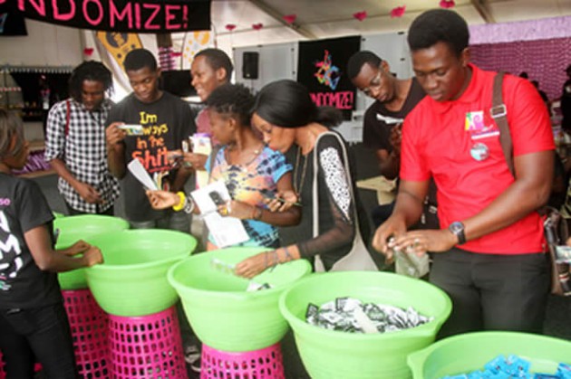 Youths look at various types of condoms that are being distributed for free at the ongoing 18th International Conference on Aids and STIs in Africa (ICASA) in Harare yesterday. — (Picture by Innocent Makawa)