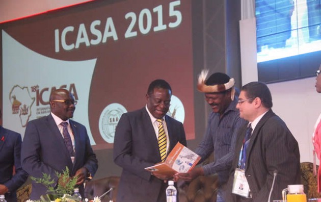 Vice President Emmerson Mnangagwa receives a booklet titled “My Daughter” from poet Albert Nyathi while International Conference on Aids and STIs in Africa (ICASA) president Dr Ihab Ahmed and Health and Child Care Minister David Parirenyatwa look on at the official opening of the conference in Harare yesterday. — (Picture by Munyaradzi Chamalimba)