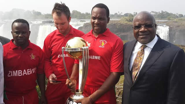 AS THE SMOKE THUNDERS . . . Zimbabwe cricketers (from left), Prosper Utseya, Brendan Taylor and Hamilton Masakadza join Zimbabwe Cricket chairman Wilson Manase as they pose with the ICC World Cup Trophy against the spectacular background of the Victoria Falls in the resort town yesterday. — (Picture by Robson Sharuko)
