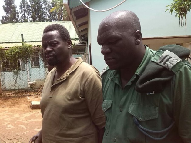 Martin Gumbura is guarded by prison officers