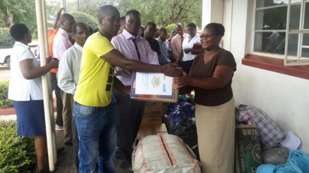 Bulawayo branch online editor, Stanford Chiwanga, hands over some of the goods donated by readers of Zimpapers publications to Tsholotsho District Administrator  Ms Nosizi Dube today.