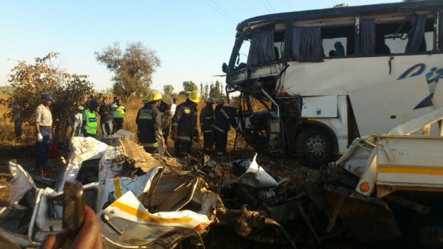 Fire fighters go through the accident scene today (Picture by Tawanda Mudimu)