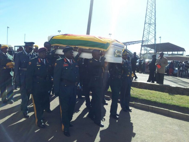 The body of Maj-Gen Bandama is carried into Stodart Hall