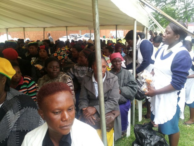 The gathered crowd receives food packs. (pic by Lloyd Gumbo)