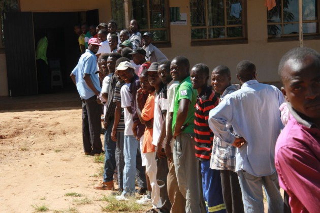 Voters stand in line to cast their ballots in Mt Darwin West