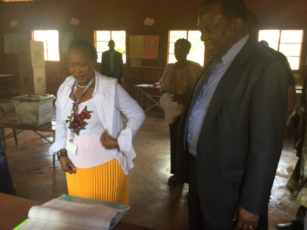 VP Mnangagwa and Cde Auxillia check for their names on the voters roll.