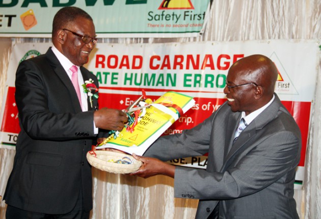 Transport and Infrastructure development MinisterDr Joram Gumbo receives new Highway Code today from Traffic Safety Council of Zimbabwe board chairperson Mr Moses Chihuri -Picture By Shelton Muchena