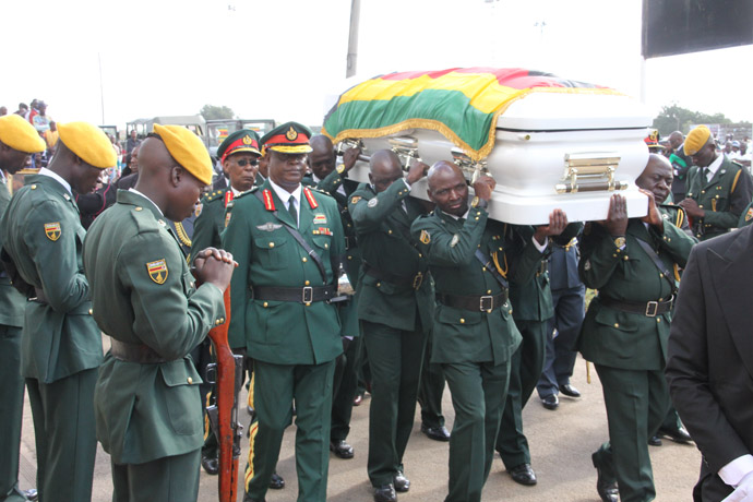 Pallbearers carry the casket into Stodart Hall