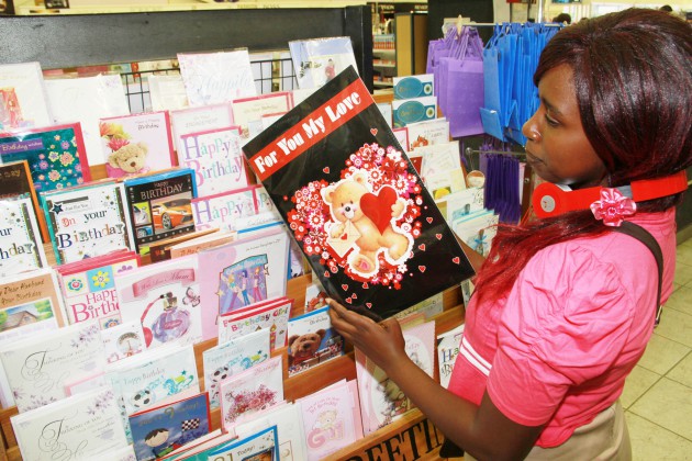 Esther Kurebwaseka going through messages in a valentine gift card.