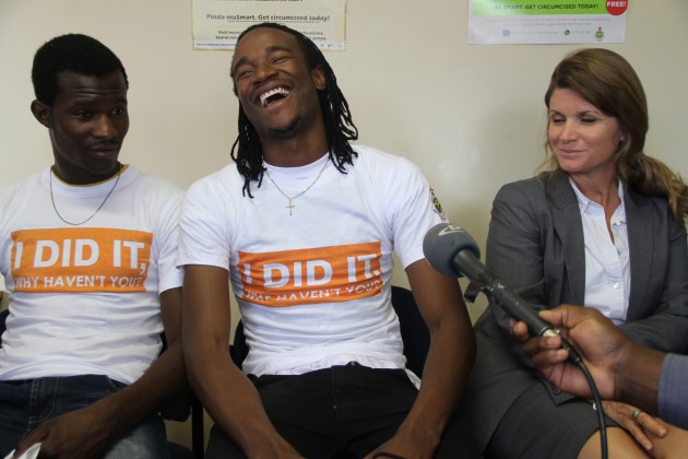 Jah Prayzah laughs during an interview in Harare today flanked by Dr Karin Hatzold, deputy director gates Male Circumcision Partnership Project (R) and his best friend Daniel Kapfumvuti (L)