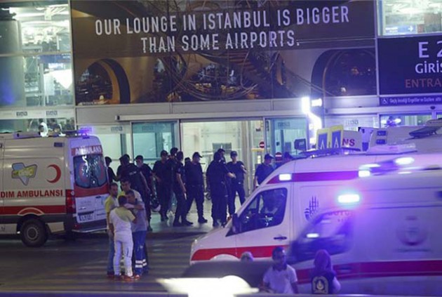 Police officers and ambulance crews outside the international arrivals terminal which was struck in what officials say was a terror attack. — DailyMail