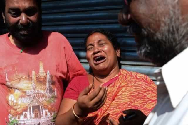 Relatives of some of the people who died in a bus accident receive news from the police at a bus operator’s office in Hyderabad. - AFP