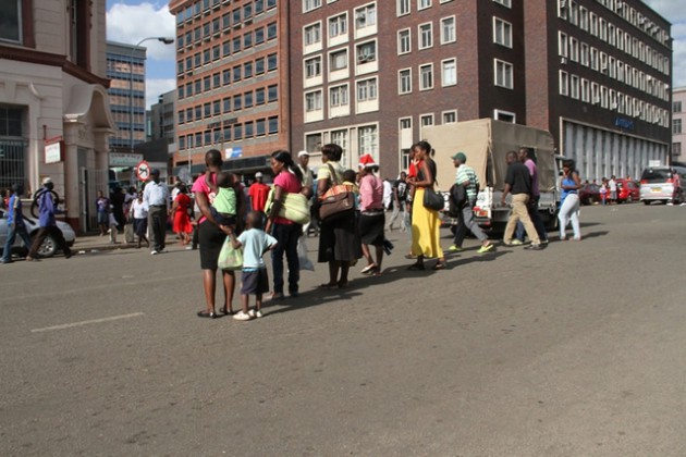 Pedestrians crossing Robert Mugabe way at undesignated point