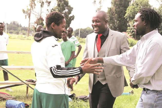 THE GREEN FAMILY . . . CAPS United president Farai Jere shares a jokke with former club captain Method Mwanjali during the team’s first day back in training in Harare yesterday before addressing the players