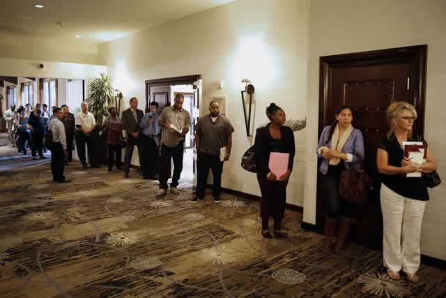 Job seekers queue to speak with recruiters at a job fair in Ontario, California, on Wednesday