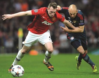 FORCING AND FIGHTING . . . Bayern Munich midfielder Arjen Robben (right) challenges Manchester United defender Phil Jones during their Uefa Champions League quarter-final first leg at Old Trafford in Manchester on Tuesday night. The match ended in a 1-1 draw. — AFP