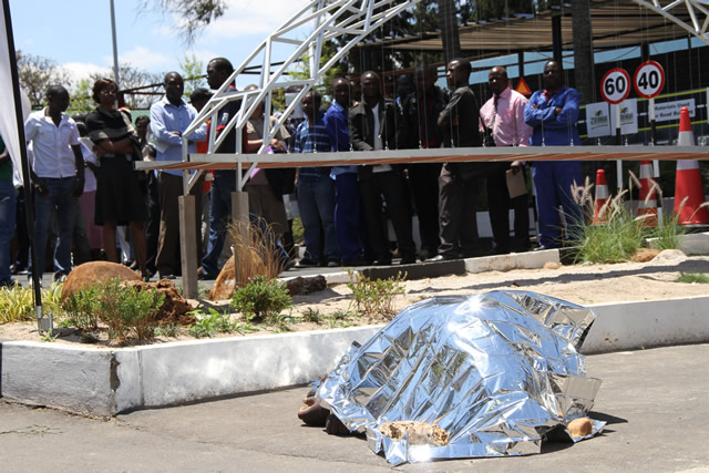 The body of Justin Janhi (covered) who collapsed at the Zinara Exhibition Park outpost.