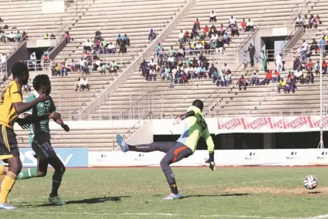 BEATEN CLEAN . . . CAPS United striker Kenneth Bulaji (centre) shoots the ball past Chicken Inn goalkeeper Elvis Chipezeze (right) for his side’s only goal of the afternoon despite the close attention of the visitors’ defender Lawrence Mhlanga during their Castle Lager Premiership match at the National Sports Stadium yesterday. — (Picture by Regis Nyandima)