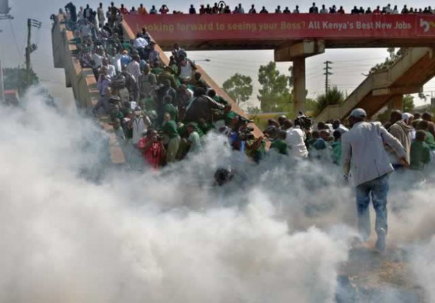 Schoolchildren from the Langata Road Primary School scramble up a bridge to escape tear gas in Nairobi yesterday. — Getty Images