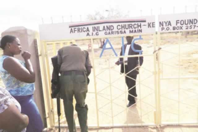 An armed guard screens congregates at the entrance to the Africa Inland Church during Easter Sunday service yesterday, follow¬ing the massacre at Garissa University College that left nearly 150 people dead (Agencies)