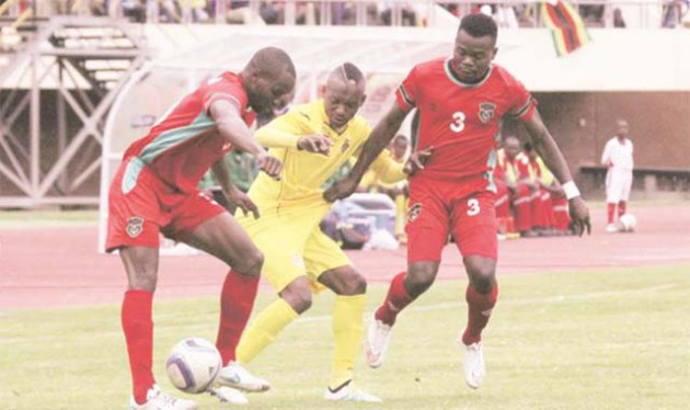 SANDWICHED . . . Zimbabwe striker Khama Billiat (centre) fights for the ball with Malawi defenders John Lanjesi (left) and Francis Mulimbika during their 2017 African Cup of Nations Group L qualifying match at the National Sports Stadium yesterday. — (Picture by Tawanda Mudimu)