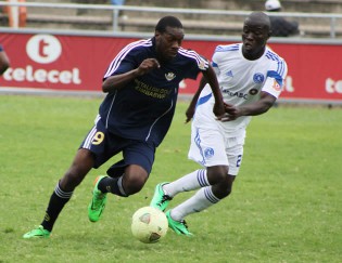 THE BALL IS MINE . . .How Mine striker Kuda Musharu (left) fights for the ball with Dynamos centre-back Temba Ndlovu during their Premiership tie at Barbourfields yesterday