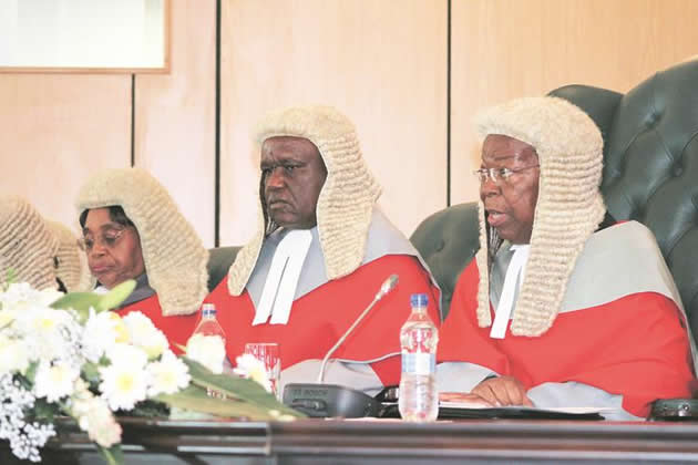 Chief Justice Godfrey Chidyausiku addresses the Judiciary while flanked by his deputy Luke Malaba (centre) and Justice Elizabeth Gwaunza at the official opening of the 2016 legal year in Harare yesterday. — (Picture by Memory Mangombe)