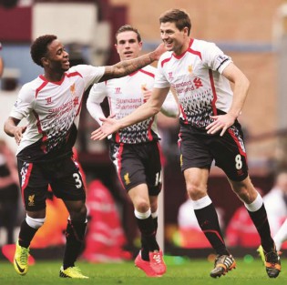 CAPTAIN FANTASTIC . . .  Liverpool midfielder Steven Gerrard (right) is congratulated by teammates after scoring the opening goal from the penalty spot during the English Premier League football match between West Ham United and Liverpool at Upton Park in London yesterday. — AFP