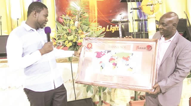 THE GLOBAL GAME . . . Prophet Walter Magaya was handed a copper-plated world map by Northern Region chairman Willard Manyengavana in Harare last month in recognition of his support and love for football in this country