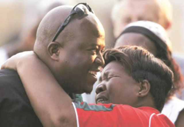 FAMILY AFFAIR . . . Zimbabwe cricket coach Steve Mangongo is hugged by his mother after leading his team to a great victory over Australia at Harare Sports Club yesterday. — AFP