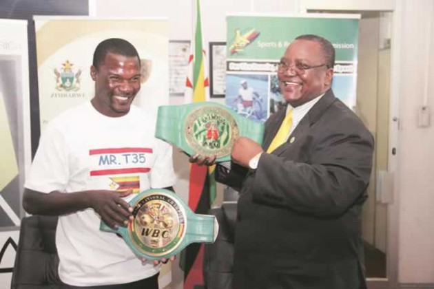 WE ARE IN THIS TOGETHER . . . World Boxing Council Welterweight champion Charles Manyuchi (left) shares a lighter moment with the Principal Director in the Ministry of Sports, Arts and Culture Bernard Dube during a send-off ceremony held for him yesterday at the ministry’s offices in Harare yesterday