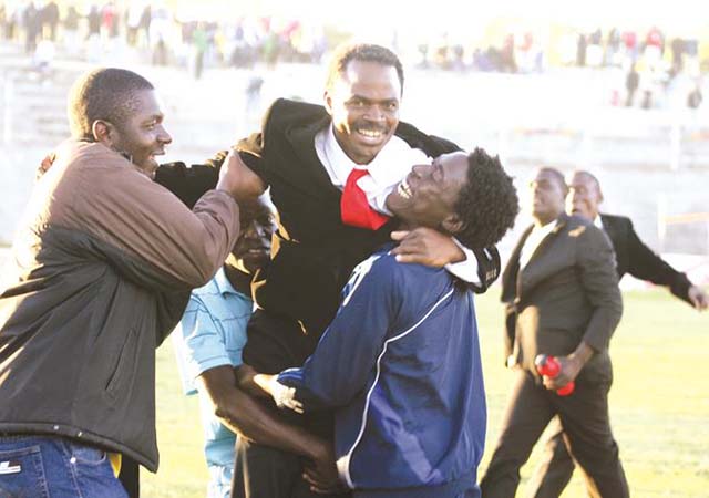 FLASHBACK . . . Coach Timothy Masachi is hoisted by his Buffaloes players after guiding them to success when he was in charge of the club