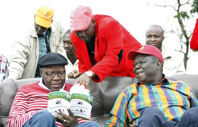 FLASHBACK . . . MDC-T organising secretary Nelson Chamisa (standing), secretary-general Tendai Biti and party leader Morgan Tsvangirai engrossed in the zanu-pf election manifesto before addressing a campaign rally in the run-up to harmonised elections last year