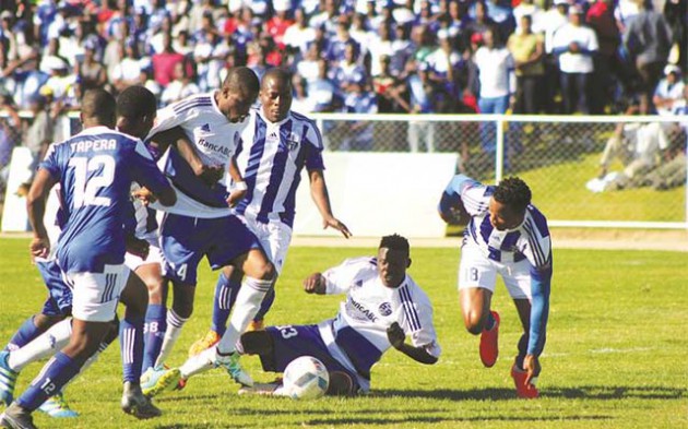 FREE FOR ALL . . . Dynamos and Ngezi Platinum players plunge into a mass battle for the ball in yesterday’s Premiership match at Baobab which ended goalless. — (Picture by Paul Mundandi)