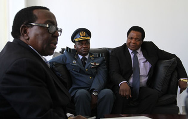 Economic Planning and Investment Promotion Minister Ambassador Simon Khaya Moyo addresses students while Air Vice Marshal Michael Tedzani Moyo (centre) and Permanent Secretary in the ministry Dr Desire Sibanda look on at the National Defence College in Harare yesterday