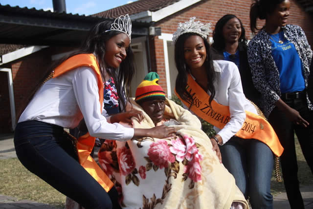 Miss Zimbabwe Thabiso Phiri (right) and first princess Tendai Hunda cover a patient at Mashambanzou Trust Care with one of the blankets they donated at the centre at the weekend