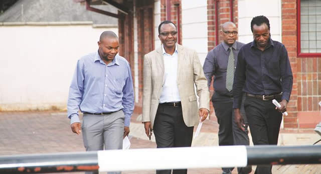 MPs Shadreck Mashayamombe, James Maridadi and Tongesayi Mudambo (far right) arrive to deliver a petition at the South African Embassy in Harare yesterday. In the background is an embassy visitor