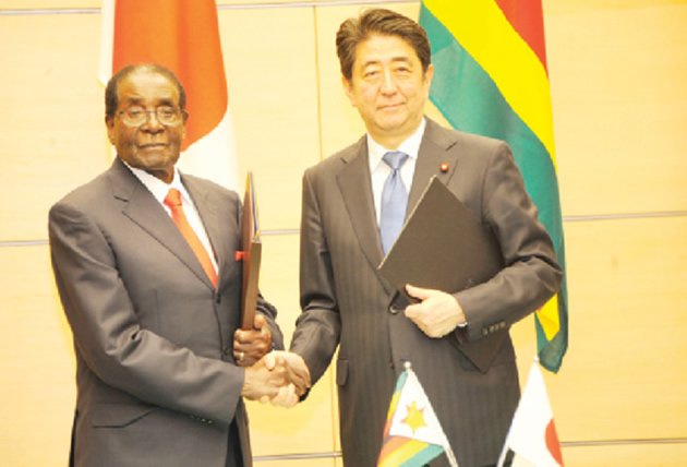 President Mugabe shakes hands with Japanese Prime Minister Shinzo Abe following a signing ceremony in Tokyo, Japan, last month