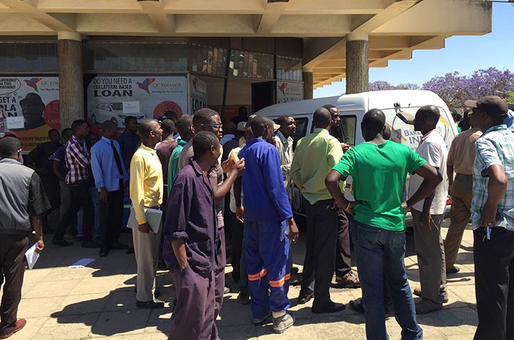 People gather around the delivery van whose driver jumped off whilst it was in motion claiming a snake had come face-to-face with him on the dashboard. The vehicle crashed into a commercial building in the CBD. 