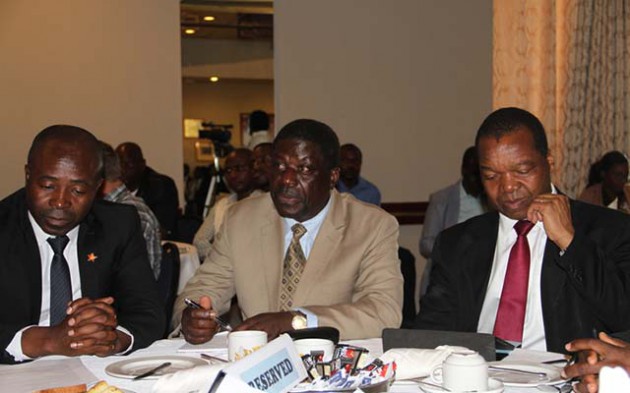 Industry and Commerce Minister Mike Bimha (centre), Reserve Bank Governor John Mangudya (right) and Confederation of Retailers Association of Zimbabwe (CRAZ) President Mr Denford Mutashu follow proceedings during a breakfast meeting on Statutory Instrument 64 of 2016 that was arranged by the retailers’ representative body in Harare yesterday. — (Picture by Wilson Kakurira)