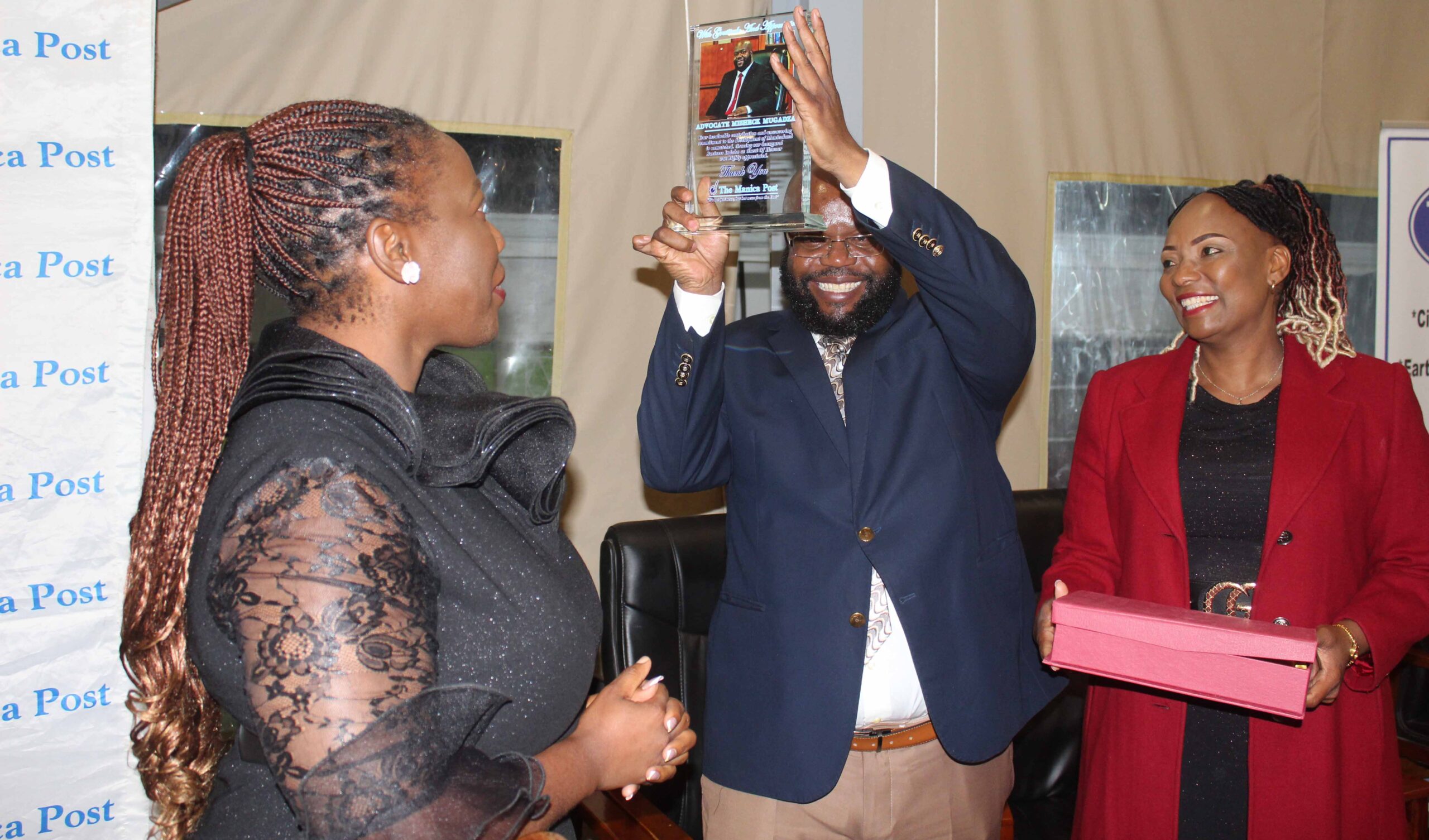 Minister of State for Manicaland Provincial Affairs and Devolution, Advocate Misheck Mugadza (centre) displays a token of appreciation for being the guest of honour, while his wife, Mrs Rose Mugadza (right) and The Manica Post Editor, Mrs Wendy Nyakurerwa-Matinde look on