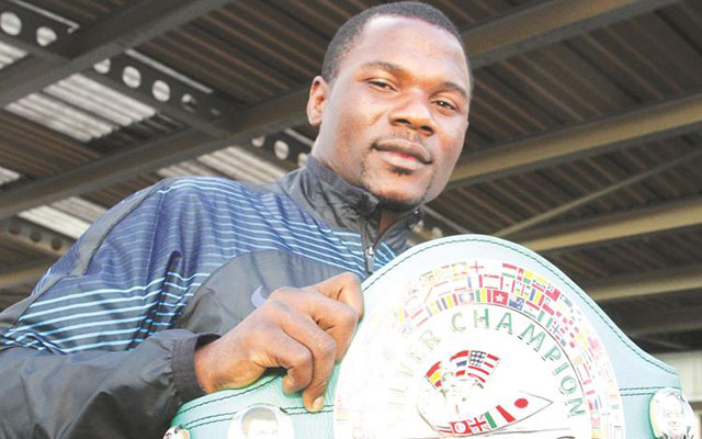 Boxer Charles Manyuchi drapped in Zimbabwe's national flag before the fight