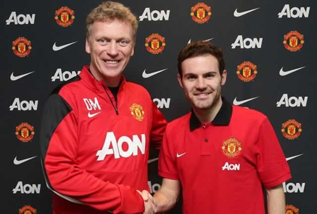 TOP SIGNING . . . Juan Mata (right) shakes hands with his new boss at Manchester United David Moyes soon after completing his move to the English Premiership soccer champions. — Mailonline.