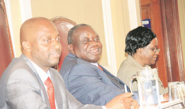 City of Harare Deputy Mayor Christopher Mbanga smiles during a full council meeting while flanked by Acting Chamber Secretary Charles Kandemiri (left) and Acting Town Clerk Josephine Ncube during a full council meeting at Town House in Harare yesterday. — (Picture by Munyaradzi Chamalimba)
